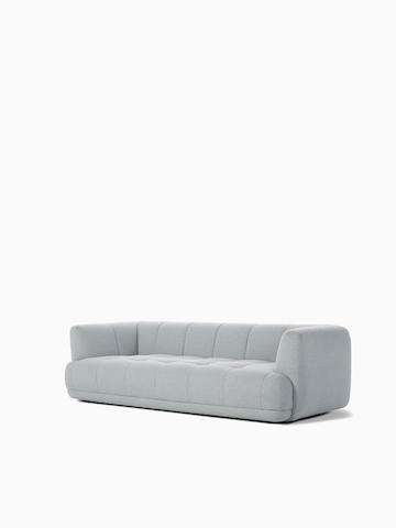 A front angle view of the Quilton Sofa in gray.