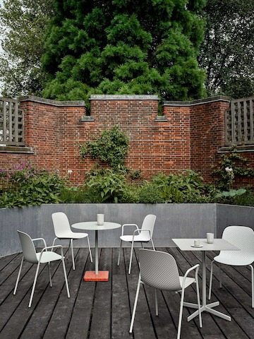 Exterior patio setting with white 13Eighty Chairs and Terrazzo Tables.