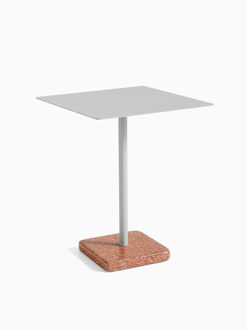 A square Terrazzo Table in light grey with a red Terrazzo base.