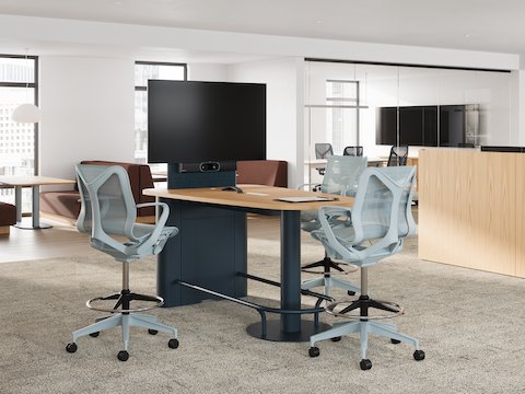 A Headway Huddle Table in a semi-enclosed space, featuring Knoll power, table-mounted monitor, and Cosm Stools.