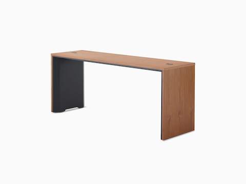 A narrow, counter-height Headway Communal Table with a medium wood top and black base viewed at a 45-degree angle.