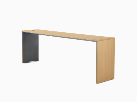 A narrow, standing-height Headway Communal Table with a light wood top and dark gray base viewed at a 45-degree angle.