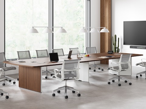 An office setting featuring a Headway conference table with a cabinet base in a large board room with Setu Chairs.