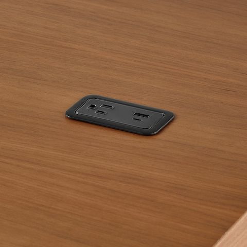 A close up of a Logic Mini with USB-C port, USB-A port, and A/C power outlet installed in the Headway communal table.