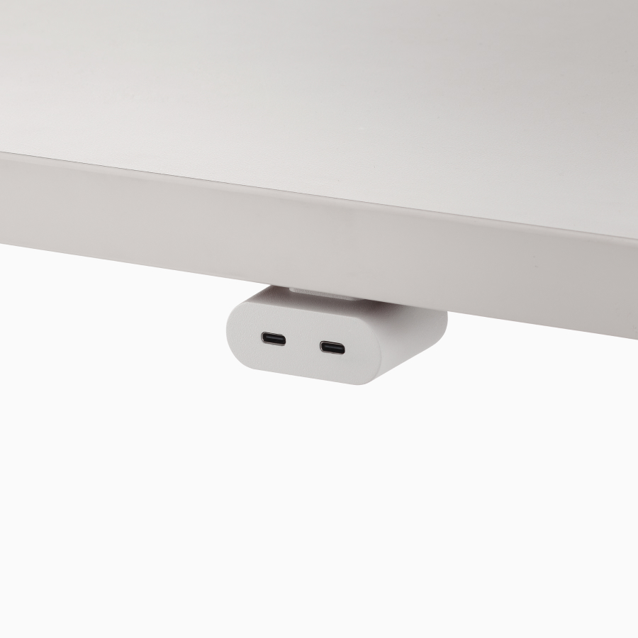 Close view of a white Ello Mini Vine USB-C power access module, attached to a white surface.