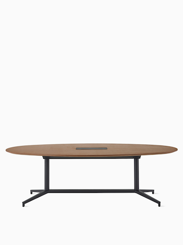 An oval Y-base Headway Conference Table with a medium wood top and black base.