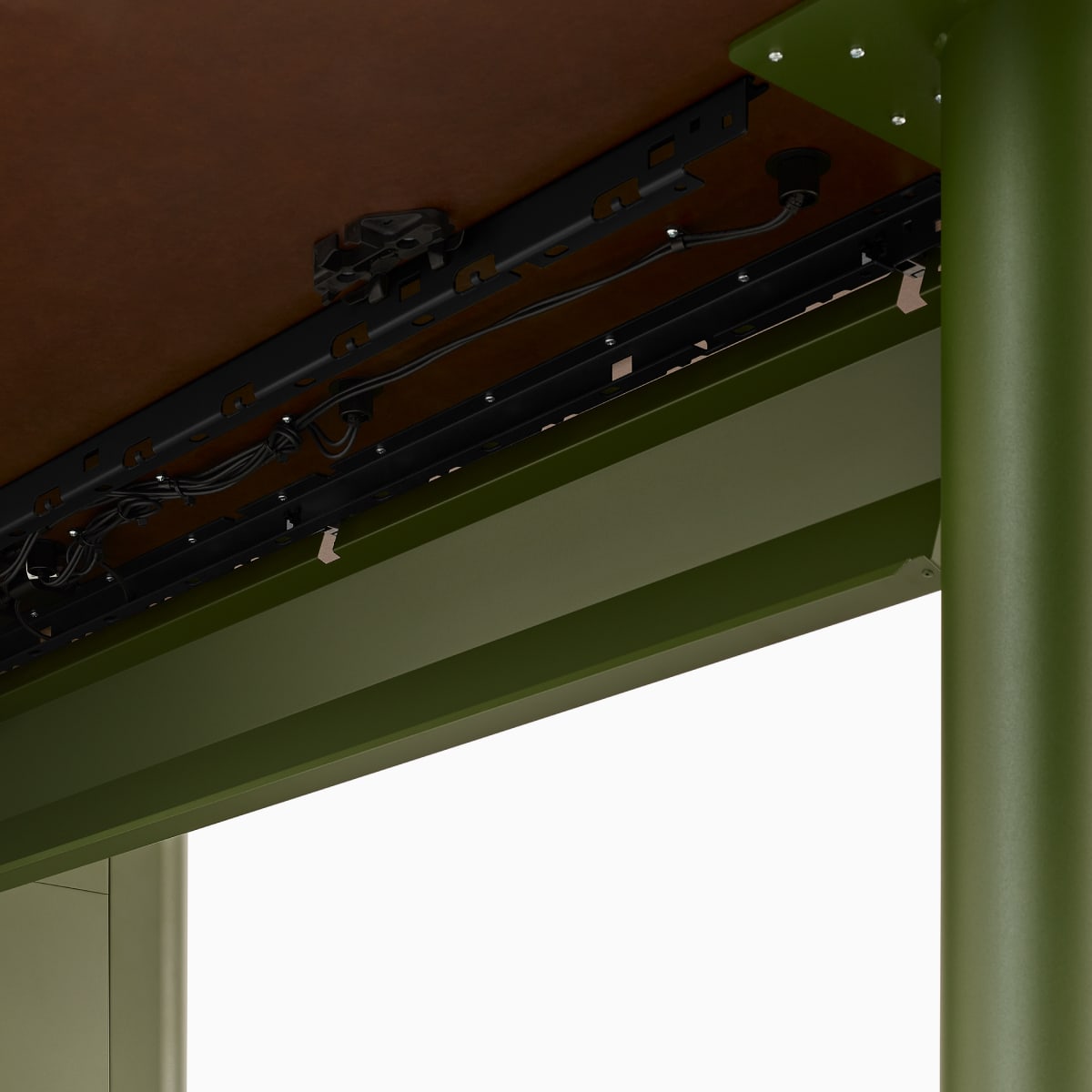 The underside of a Headway Huddle Table with a cable management trough.