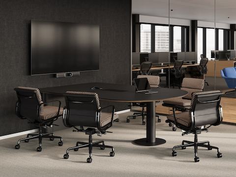 A Headway Huddle Table in an enclosed space with a wall-mounted monitor and camera.