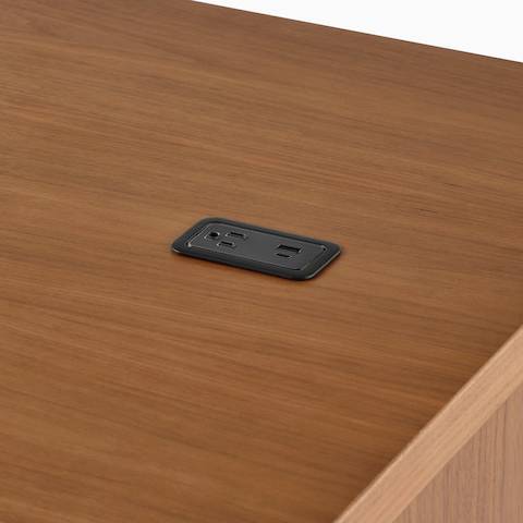 A close up of a Logic Mini with USB-C port, USB-A port, and A/C power outlet installed in a Headway table.