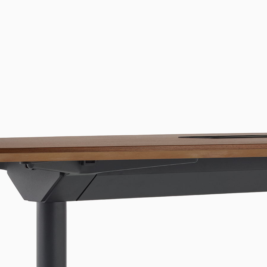 Close view of a Headway table with a tech bucket on top and a cable management trough below.