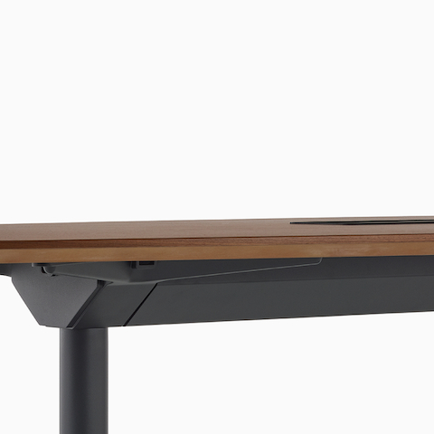Close view of a Headway table with a tech bucket on top and a cable management trough below.