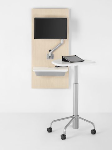 A tablet computer sits atop a mobile Intent Solution table, which is detached from the companion wall unit. 