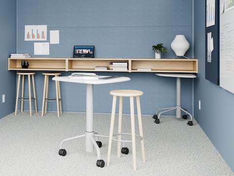 A light blue project room with an Intent Solution mobile, height-adjustable table and Mattiazzi Solo Stools, featuring technology from Logitech.