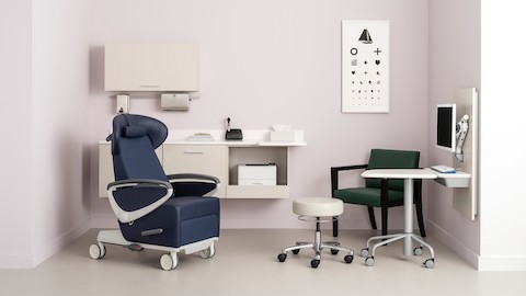 An exam room with Mora System casework in a light wood laminate, a blue Ava patient recliner, an Intent Solution wall unit and mobile, height adjustable table, and a Brava side chair.
