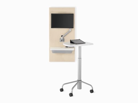 An Intent Solution technology support wall unit in an ash finish with a white surface and a silver monitor arm with monitor.