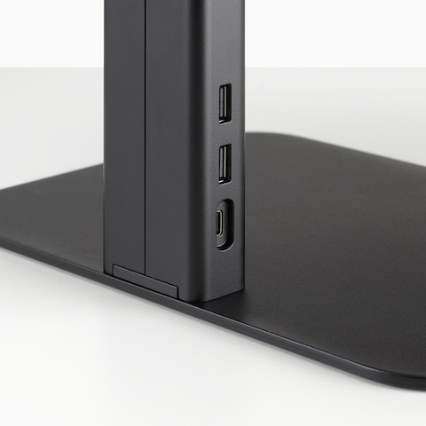 A close-up view of the data ports on a black Lana Laptop Stand.