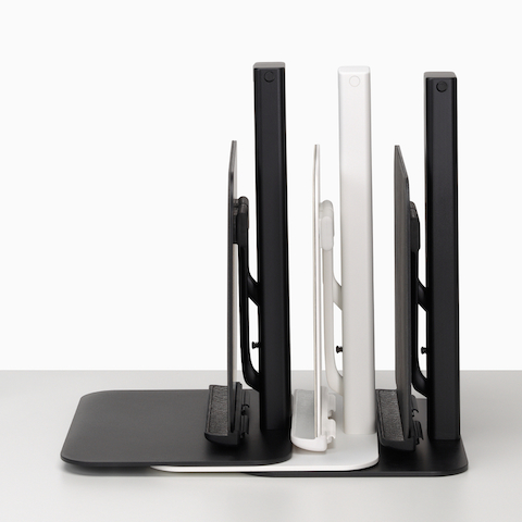 A stack of black and white Lana Laptop Stands viewed from the side.