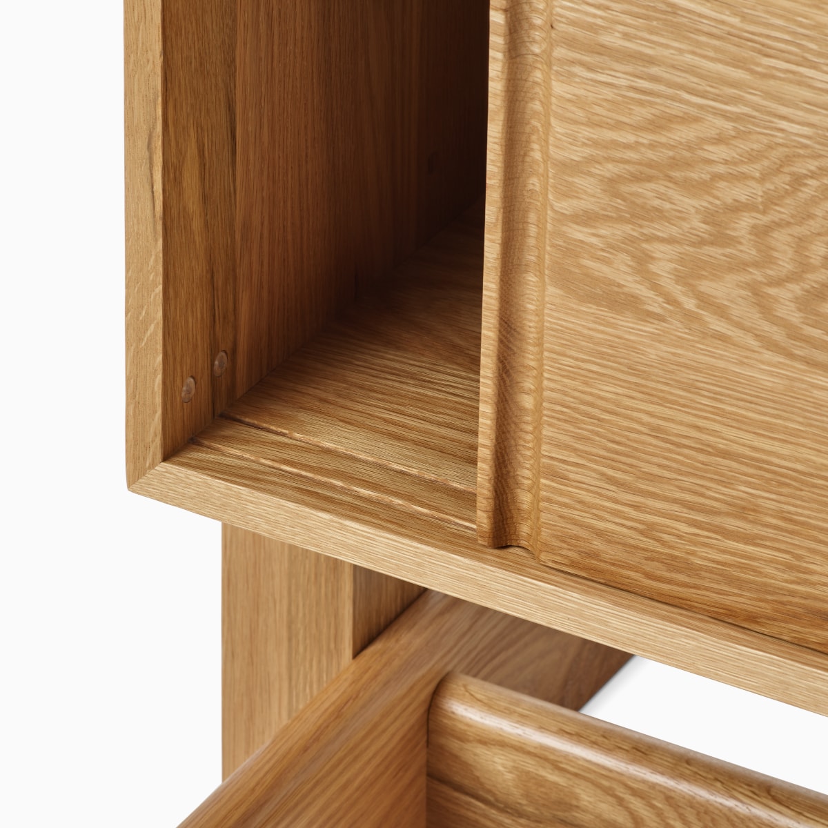 A detail view of the Land Storage door track in oak.