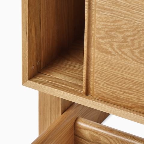 A detail view of the Land Storage door track in oak.