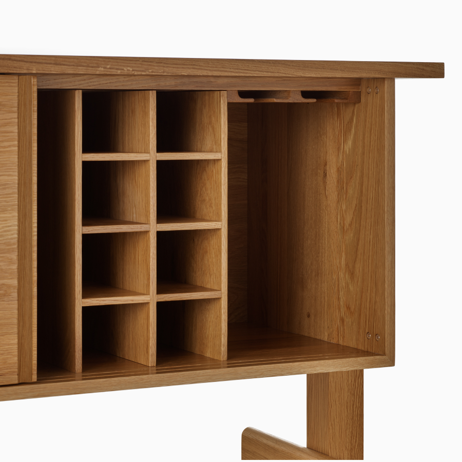 A detail view of the Land Credenza's bottle and glass storage insert empty.