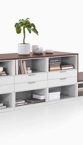 A Meridian Storage unit with open shelves and drawers. Select to go to the Herman Miller storage landing page. 