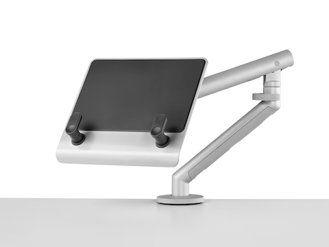 An adjustable Flo Monitor Arm supports an empty Laptop Mount, which has two brackets to hold a notebook computer. An adjustable Flo Monitor Arm supports an empty Laptop Mount, which has two brackets to hold a notebook computer.