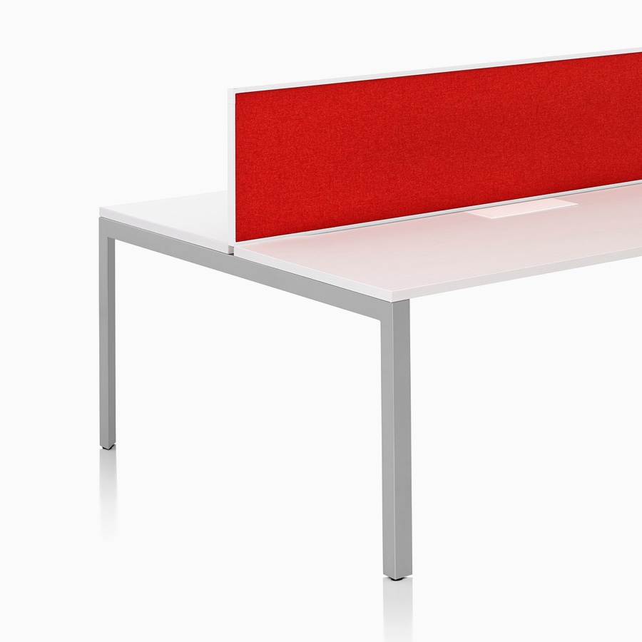 A Layout Studio bench for four with a white laminate top, gray legs, and red framed fabric center privacy screens.