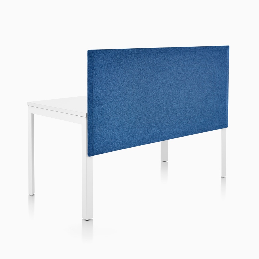 Viewed at an angle, the front side of a blue tapered-edge fabric, surface-attached privacy screen attached to a single-sided Layout Studio bench.