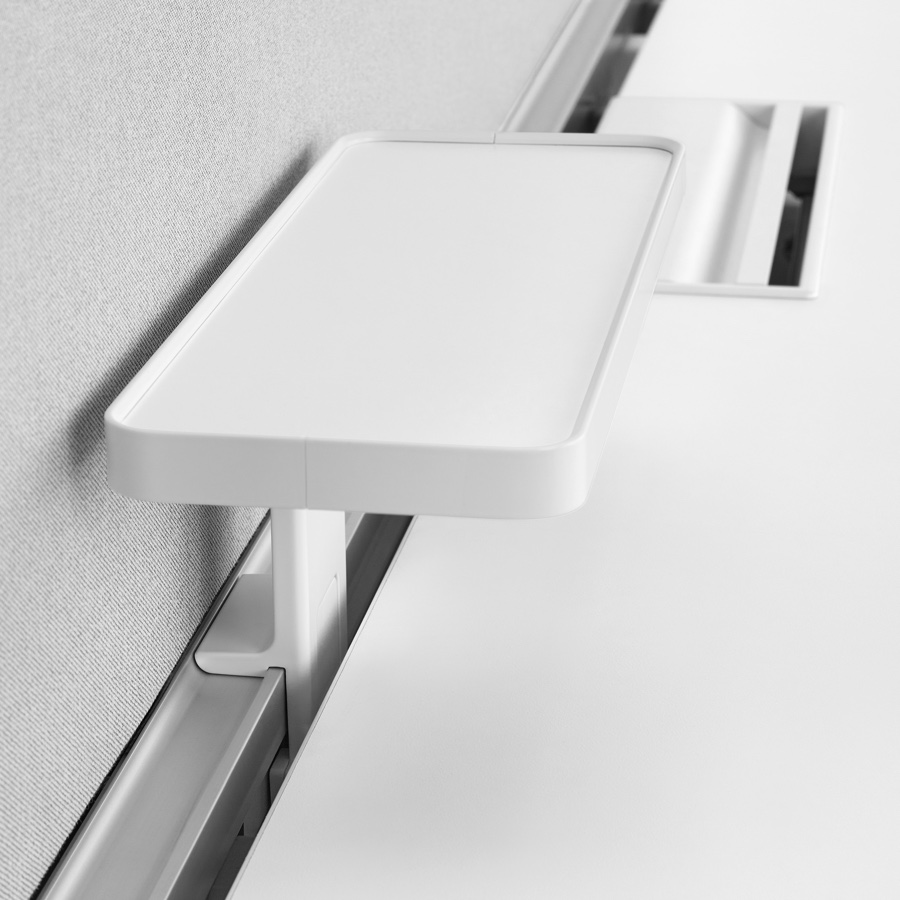 Close-up of a white, Ubi Work Tool, Attached Shelf installed on the performance rail of a Layout Studio bench.