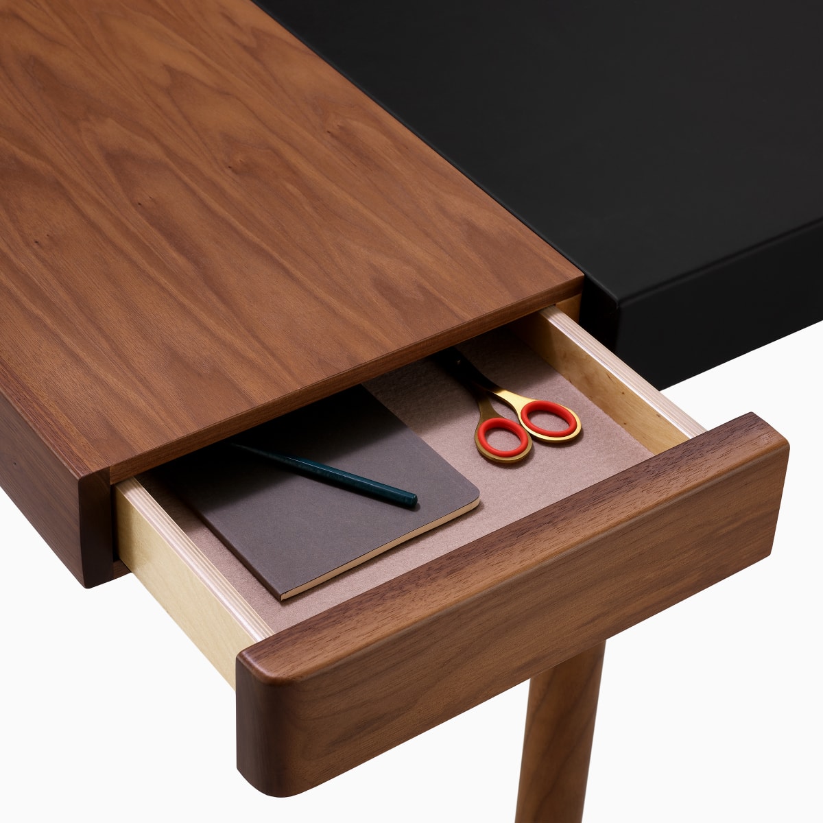 Detail of a felt-lined open drawer on the left side of a Leatherwrap Sit-to-Stand Desk.