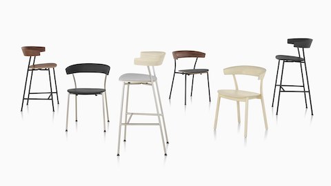 A grouping of Leeway Chairs and stools showcasing the various base materials, finishes, and upholstery options.