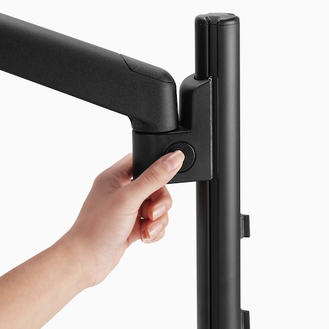 Close-up of single Lima Monitor Arm push-button technology in black.