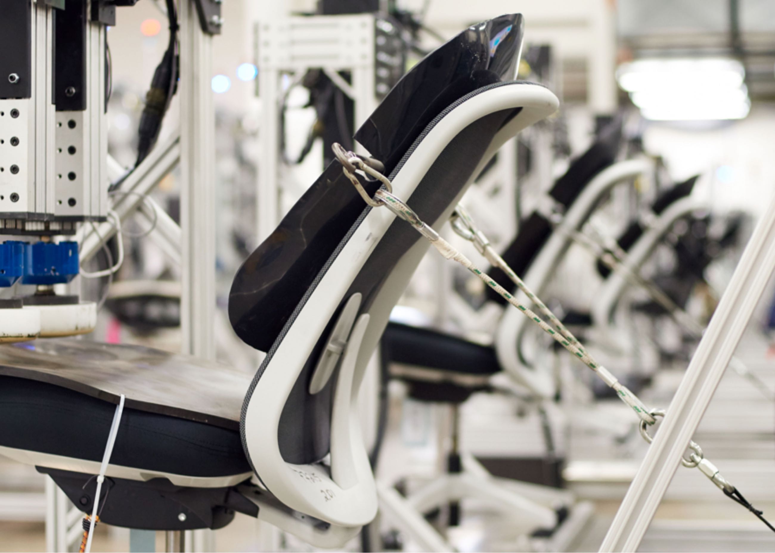 Blue and light grey Lino Chair being tested in the Herman Miller Test Lab.