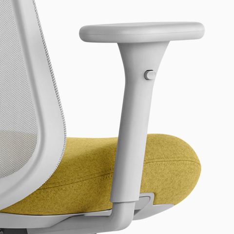 Close up image of a gray and yellow Lino Chair with adjustable sacral lumbar support and adjustable height arms, viewed from the back at an angle.