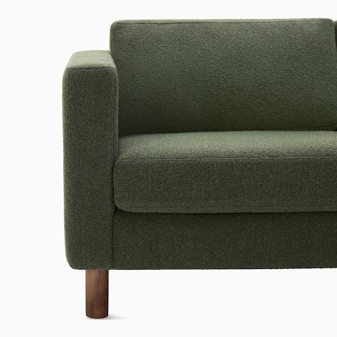 Detail view of three seater Lispenard Sofa, 17 inches in dark green textile and 6 inch walnut legs.