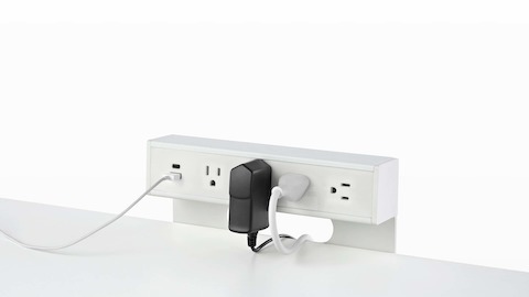 USB-A port and cable, USB-C port, and four A/C power outlets with two cables plugged into an attached table power source