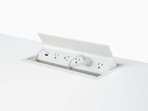 USB-A port, USB-C port with cable, and five A/C power outlets with one cable plugged into an embedded table power source. USB-A port, USB-C port with cable, and five A/C power outlets with one cable plugged into an embedded table power source.
