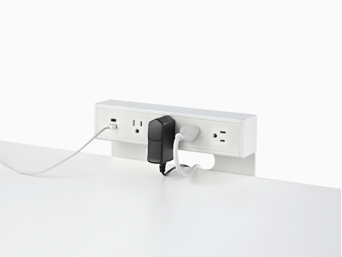 USB-A port and cable, USB-C port, and four A/C power outlets with two cables plugged into an attached table power source.