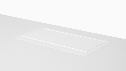 A pop-up Logic power port in the closed position, its lid flush with the work surface. A pop-up Logic power port in the closed position, its lid flush with the work surface.