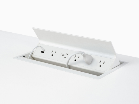 USB-A port, USB-C port with cable, and five A/C power outlets with one cable plugged into an embedded table power source. USB-A port, USB-C port with cable, and five A/C power outlets with one cable plugged into an embedded table power source.