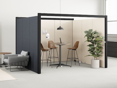 An open plan office with three Prospect solo coves positioned near a single table with stools. The single table is connected to power and data by a Logic Reach Electrical Hub sitting under its base.
