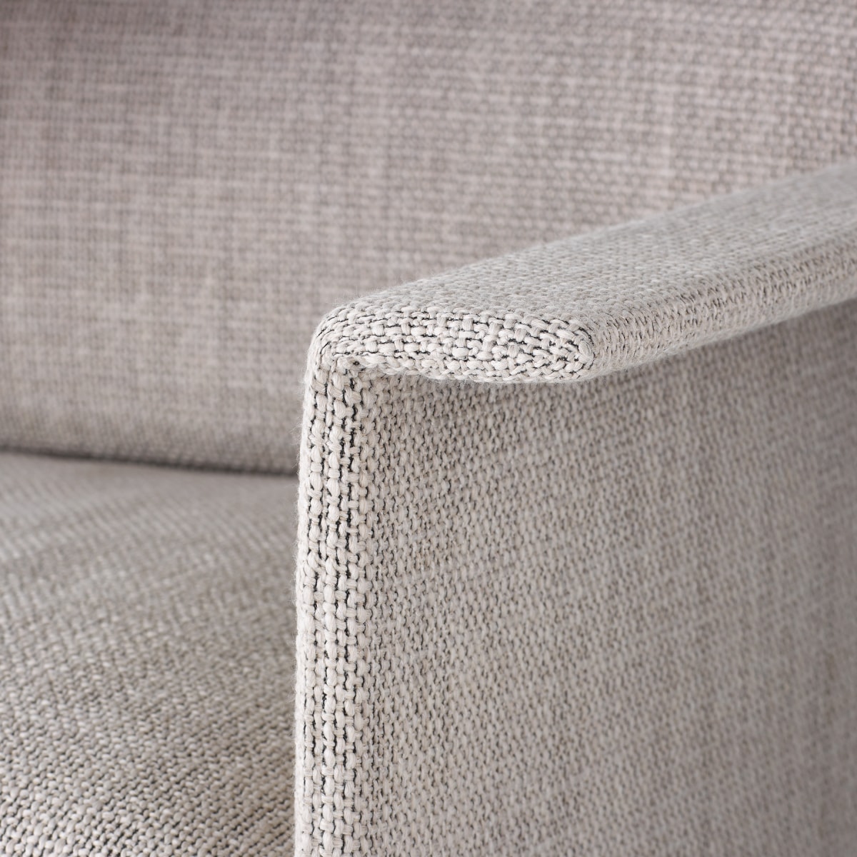 A detailed view of a Mantle Club Chair arm upholstered in Capri Stone.