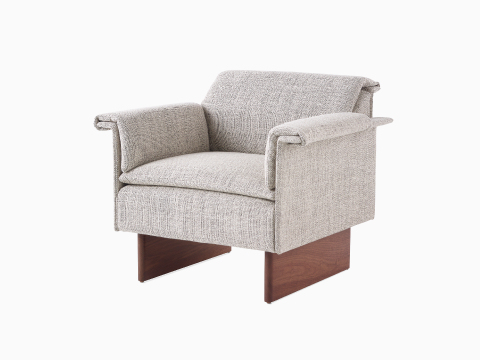 Angled view of a Mantle Club Chair upholstered in Capri Stone on a Walnut Wood Base. Angled view of a Mantle Club Chair upholstered in Capri Stone on a Walnut Wood Base.