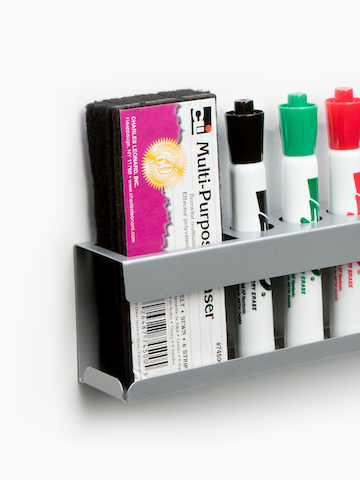 A Marker/Eraser Holder containing four dry-erase markers and an eraser. Select to go to the Marker/Eraser Holder product page.