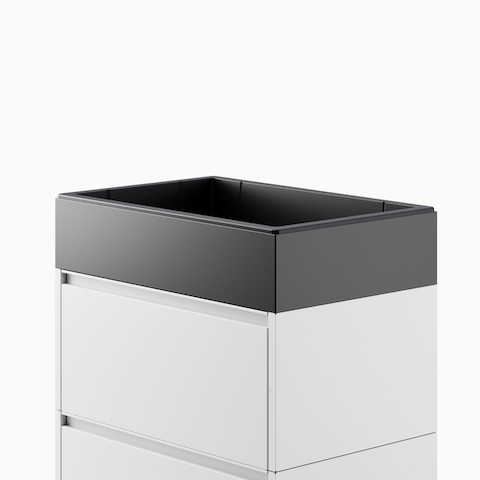 Close up image a light gray Meridian Storage lateral file, with a black planter top.