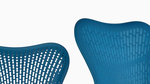 Two blue Mirra 2 office chairs showing the two available back options: Tri-Flex Back and fabric-covered Butterfly Back.