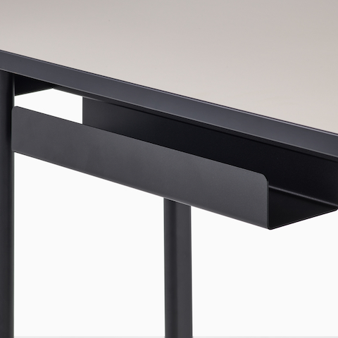 Detail view of the cord management on a Mode desk in black with sandstone top.