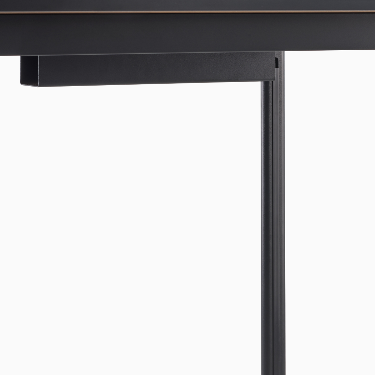 Detail view of steel legs in black on a Mode desk.