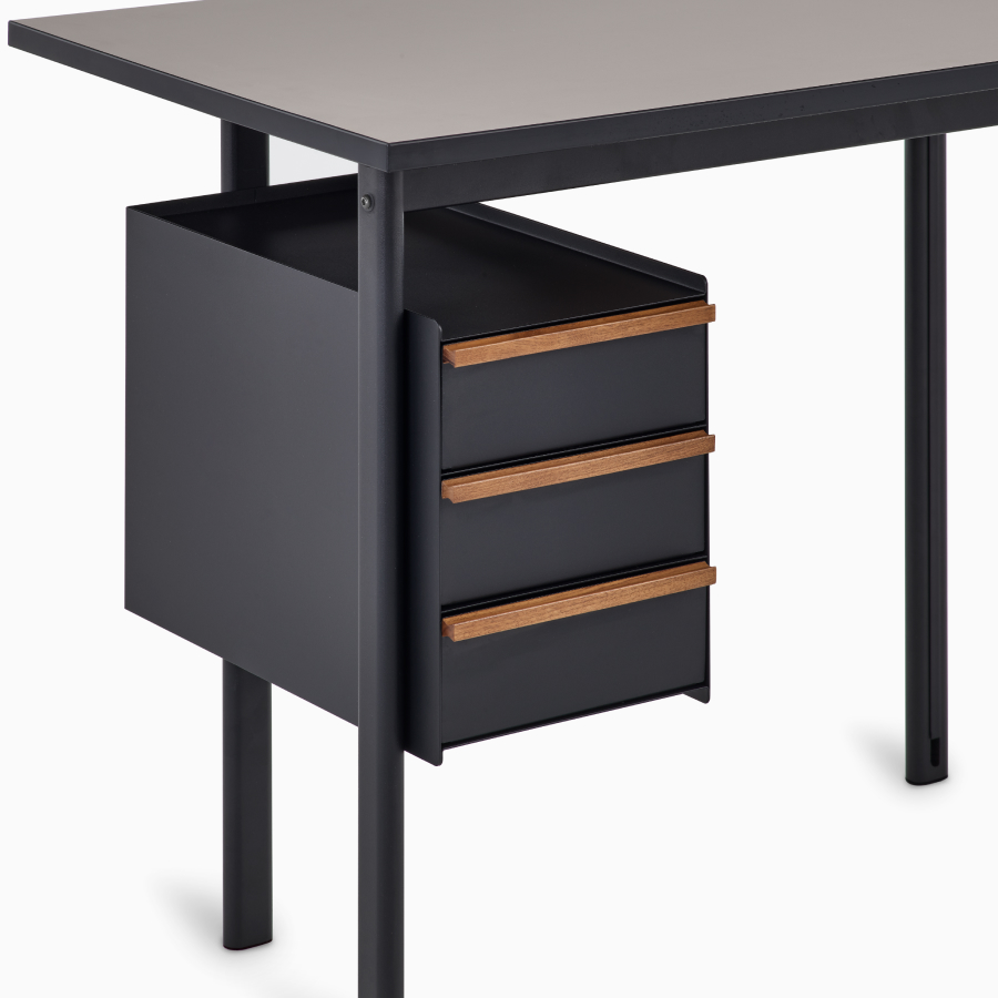Detail view of drawers in black with walnut pulls on a Mode desk.
