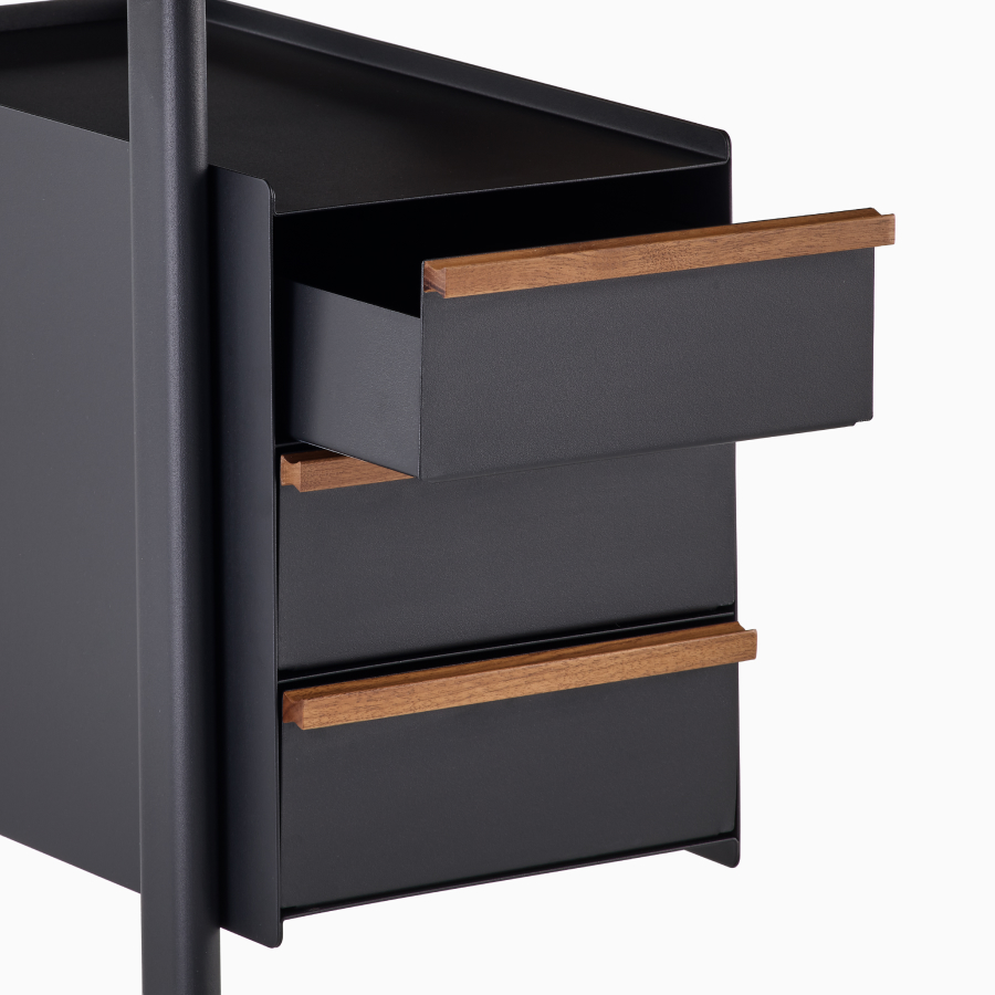 Detail view of drawers in black with walnut pulls with the top drawer open on a Mode desk.